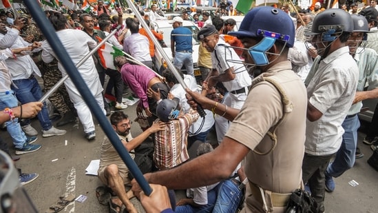 BJP members and security personnel clash during a protest organised to mark the completion of one year of the rape and murder of a trainee doctor at RG Kar hospital. (PTI)