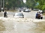 Commuters wade through a waterlogged road in an area in Prayagraj. (File Photo) Commuters wade through a waterlogged road in an area in Prayagraj. (File Photo)