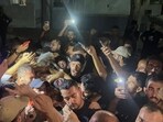 Palestinians hold the body of Al Jazeera journalist Anas Al-Sharif, who Israel's military and Al Jazeera say was killed by an Israeli strike, in Gaza City, August 11, 2025.