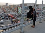 A Taliban fighter stands guard on a bridge in Kabul, Afghanistan.