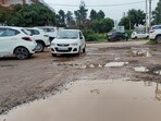 The potholes, submerged in muddy waters, makes every day commuter a risky affair for Panchkula residents. (Sant Arora/HT) The potholes, submerged in muddy waters, makes every day commuter a risky affair for Panchkula residents. (Sant Arora/HT)