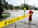 WAUWATOSA, WISCONSIN - AUGUST 10: Caution tape marks off a pedestrian pathway from flooding on August 10, 2025 in downtown Wauwatosa, Wisconsin. 