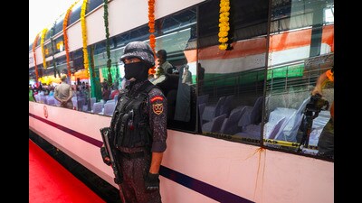 A security official stands guard outside a Vande Bharat Express train, which was virtually inaugurated by Prime Minister Narendra Modi, at Katra Railway station, in Reasi district on Sunday. (PTI) A security official stands guard outside a Vande Bharat Express train, which was virtually inaugurated by Prime Minister Narendra Modi, at Katra Railway station, in Reasi district on Sunday. (PTI)