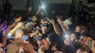 Palestinians hold the body of Al Jazeera journalist Anas Al-Sharif, who Israel's military and Al Jazeera say was killed by an Israeli strike, in Gaza City, August 11, 2025. (REUTERS)