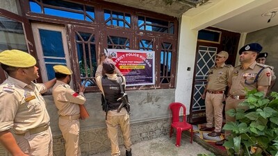 Police personnel put up an 'attachment' notice on a residential property of an alleged drug peddler under the Narcotic Drugs and Psychotropic Substances Act (NDPS), in Kulgam. (PTI File) Police personnel put up an 'attachment' notice on a residential property of an alleged drug peddler under the Narcotic Drugs and Psychotropic Substances Act (NDPS), in Kulgam. (PTI File)