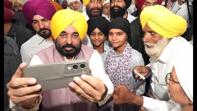 Punjab chief minister Bhagwant Singh Mann with people at Satauj village in Sangrur on Sunday. (HT Photo) Punjab chief minister Bhagwant Singh Mann with people at Satauj village in Sangrur on Sunday. (HT Photo)