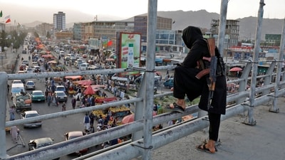 A Taliban fighter stands guard on a bridge in Kabul, Afghanistan. (Reuters)