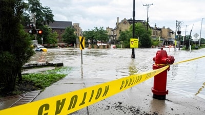 WAUWATOSA, WISCONSIN - AUGUST 10: Caution tape marks off a pedestrian pathway from flooding on August 10, 2025 in downtown Wauwatosa, Wisconsin. (Getty Images via AFP) WAUWATOSA, WISCONSIN - AUGUST 10: Caution tape marks off a pedestrian pathway from flooding on August 10, 2025 in downtown Wauwatosa, Wisconsin. (Getty Images via AFP)