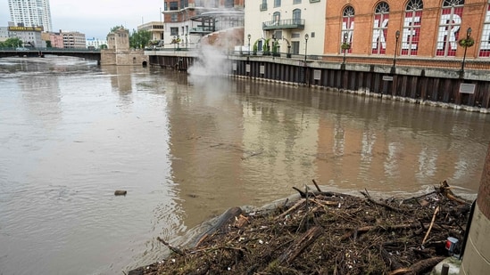 Debris piles up on a bridge piling on the Milwaukee River after heavy rain in the area on August 10, 2025 in Milwaukee, Wisconsin. Heavy downpours brought as much as 13 inches of rain to parts of southeast Wisconsin overnight, resulting in widespread flooding across the region.(Getty Images via AFP)