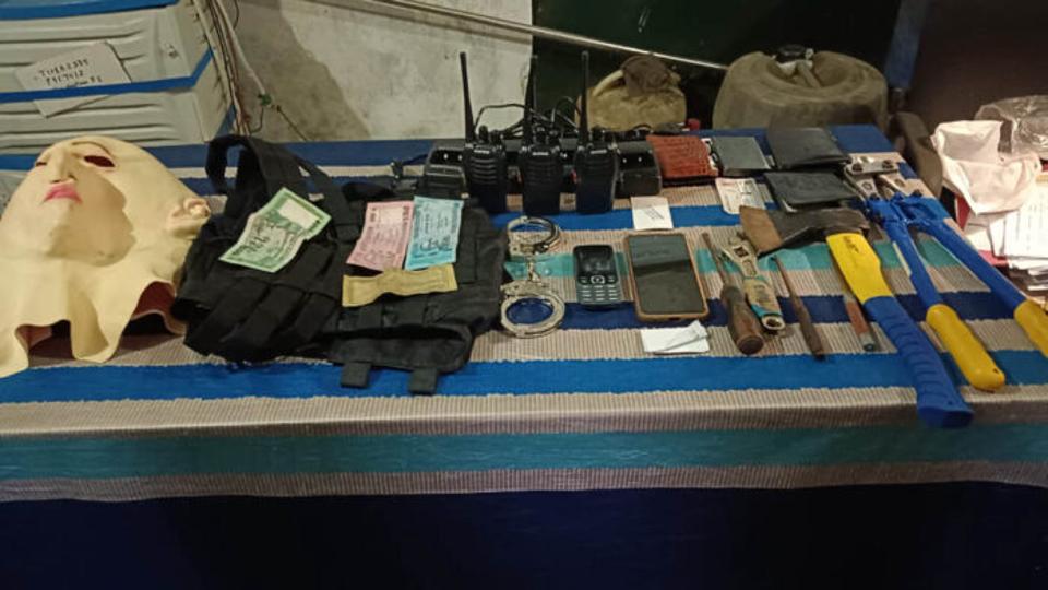 The security forces have seized pistols, machetes, handcuffs, Bangladeshi currency, wire cutters, masks, radio sets, mobile phones, cash, bags, clothes (HT Sourced) The security forces have seized pistols, machetes, handcuffs, Bangladeshi currency, wire cutters, masks, radio sets, mobile phones, cash, bags, clothes (HT Sourced)