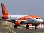 easyJet has suspended a pilot who was spotted drunk and naked in a hotel bar.