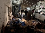 Palestinians inspect the site of an Israeli strike where Al Jazeera says its journalists Anas Al Sharif, Mohammed Qreiqeh and three photojournalists were killed, in Gaza City