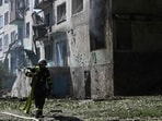 An Ukrainian firefighter carries a water pump to extinguish fire in a residential building at the site of a Russian drone strike in the town of Bilozerske, Donetsk region An Ukrainian firefighter carries a water pump to extinguish fire in a residential building at the site of a Russian drone strike in the town of Bilozerske, Donetsk region