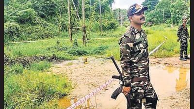 Dakshina Kannada: Security personnel stand guard near the site of the alleged mass burial, at Dharmasthala, in Dakshina Kannada district. (PTI PHOTO) Dakshina Kannada: Security personnel stand guard near the site of the alleged mass burial, at Dharmasthala, in Dakshina Kannada district. (PTI PHOTO)