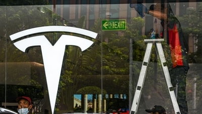 Workers prepare for the opening of the new Tesla store in New Delhi. (Bloomberg)