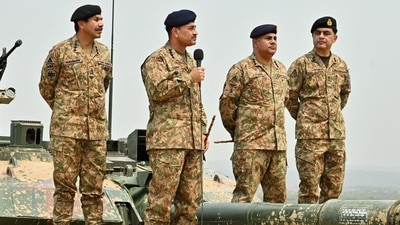 Chief of Army Staff of Pakistan Asim Munir holds a microphone during his visit at the Tilla Field Firing Ranges (TFFR) to witness the Exercise Hammer Strike, a high-intensity field training exercise conducted by the Pakistan Army's Mangla Strike Corps, in Mangla, Pakistan. (Reuters)