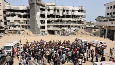 Mourners carry bodies of Palestinians, including journalists and a medic, killed in an overnight Israeli strike, ahead of a group funeral outside the Al-Shifa Hospital in Gaza City. (Omar Al Qattaa/AFP) Mourners carry bodies of Palestinians, including journalists and a medic, killed in an overnight Israeli strike, ahead of a group funeral outside the Al-Shifa Hospital in Gaza City. (Omar Al Qattaa/AFP)