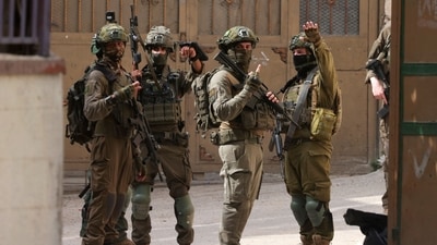 Israeli soldiers gesture during a raid at the Balata refugee camp east of Nablus city in the occupied West Bank on August 11, 2025. (Jaafar Ashtiyeh/AFP) Israeli soldiers gesture during a raid at the Balata refugee camp east of Nablus city in the occupied West Bank on August 11, 2025. (Jaafar Ashtiyeh/AFP)