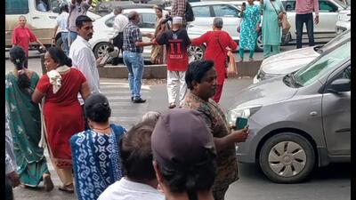 Protesters briefly stopped traffic on the Solapur Highway near Fatimanagar and forcefully crossed the road to highlight the dangers faced by pedestrians since the junction was closed. (HT Photo)