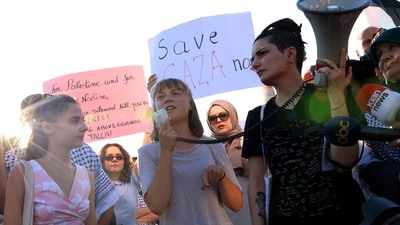 Swedish climate campaigner Greta Thunberg (C) speaks into a loudspeaker as she takes part in a demonstration to support the population of Gaza (AFP)