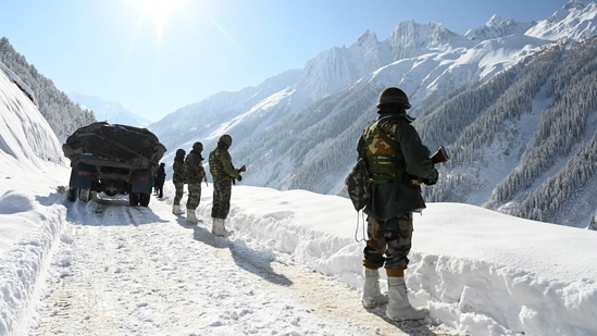 Indian army soldiers walk along a road near Zojila mountain pass that connects Srinagar to the union territory of Ladakh, bordering China. (Representational image/AFP)