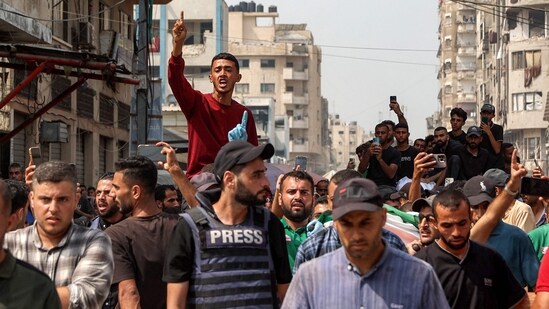 Mourners march with the bodies of the Al Jazeera journalists who were killed in an overnight Israeli strike on their tent in Gaza City, from Al-Shifa hospital to their burial at the Sheikh Radwan cemetery in Gaza City on August 11, 2025. Qatari broadcaster Al Jazeera said on August 11, that five of its journalists were killed in an Israeli strike. Al Jazeera said five had been killed: correspondents Anas al-Sharif and Mohammed Qreiqeh along with camera operators Ibrahim Zaher, Mohammed Noufal and Moamen Aliwa.(Omar Al Qattaa/AFP)