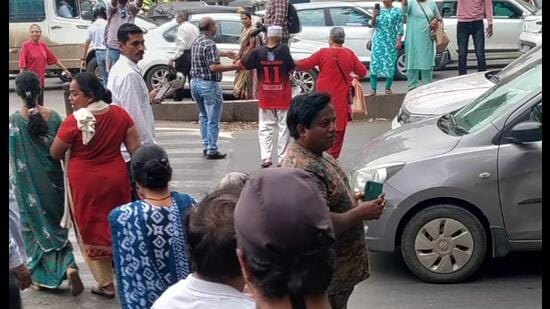 Protesters briefly stopped traffic on the Solapur Highway near Fatimanagar and forcefully crossed the road to highlight the dangers faced by pedestrians since the junction was closed. (HT Photo)