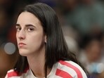 Caitlin Clark #22 of the Indiana Fever watches from the bench during the first half of the WNBA game against the Phoenix Mercury 