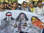 Doctors and others take part in a protest rally to mark one year of the rape and murder of a trainee doctor at the RG Kar Medical College and Hospital, in Kolkata, on Aug. 9 (PTI)