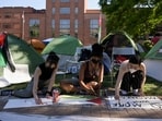 Activists make protest signs inside a pro-Palestinian encampment at George Washington University in Washington.