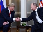 Russian President Vladimir Putin (R) and US President Donald Trump shake hands before a meeting in Helsinki on July 16, 2018. 