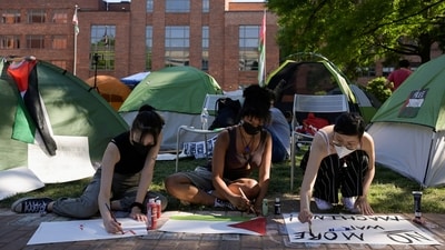 Activists make protest signs inside a pro-Palestinian encampment at George Washington University in Washington. (REUTERS)