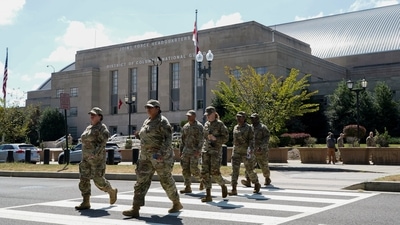 US military personnel walk outside the D.C. Armoury after US President Donald Trump's announcement to deploy the National Guard and federalise the Metropolitan Police Department. (REUTERS)