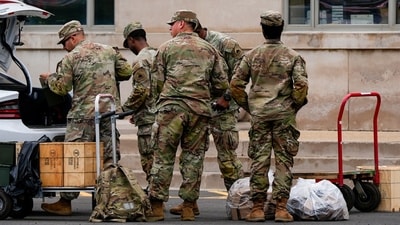 National Guard troops load supplies into a car trunk outside the District of Columbia National Guard Headquarters, Tuesday, Aug. 12, 2025, in Washington. (AP Photo/Julia Demaree Nikhinson) (AP) National Guard troops load supplies into a car trunk outside the District of Columbia National Guard Headquarters, Tuesday, Aug. 12, 2025, in Washington. (AP Photo/Julia Demaree Nikhinson) (AP)