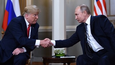 Russian President Vladimir Putin (R) and US President Donald Trump shake hands before a meeting in Helsinki on July 16, 2018. (AFP)