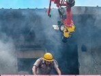 An articulated water tower machine was also used to sprinkle water on the 4th floor terrace, the chief fire officer said. (Sunil Ghosh/HT Photo)