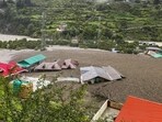 The scene of flash floods in Dharali. (PTI) The scene of flash floods in Dharali. (PTI)