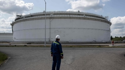 A worker stands at the oil tank terminal of the state-run company MERO, which transports crude oil and protects the strategic crude oil reserves of the Czech Republic, on June 17, 2025 in Nelahozeves, near Kralupy nad Vltavou. The Czech Republic has phased out Russian oil in a painstaking process taking much longer than the three years since Russia's invasion of Ukraine, its mastermind Jaroslav Pantucek, CEO and board chairman of Mero said. (Photo by Michal Cizek / AFP) (AFP)