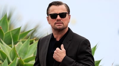 Leonardo DiCaprio stopped by police in Ibiza during a routine security check at a private party, leading to a brief identification encounter before he and his group were allowed entry. (Photo by Valery HACHE / AFP) (AFP) Leonardo DiCaprio stopped by police in Ibiza during a routine security check at a private party, leading to a brief identification encounter before he and his group were allowed entry. (Photo by Valery HACHE / AFP) (AFP)