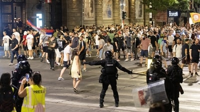 The rival groups hurled flares, rocks, firecrackers and bottles at each other in Belgrade. (REUTERS)