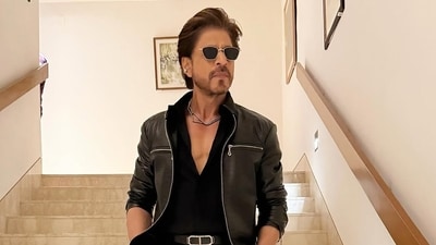Guess who this is?This is a picture of Shah Rukh Khan! The actor looks dapper in an all-black outfit and a diamond necklace for the IPL opening ceremony. Guess who this is?This is a picture of Shah Rukh Khan! The actor looks dapper in an all-black outfit and a diamond necklace for the IPL opening ceremony.