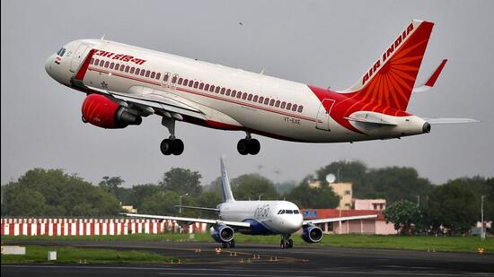 An Air India Airbus A320-200 aircraft takes off as an IndiGo Airlines aircraft waits for clearance at Ahmedabad airport. (REUTERS FILE PHOTO)