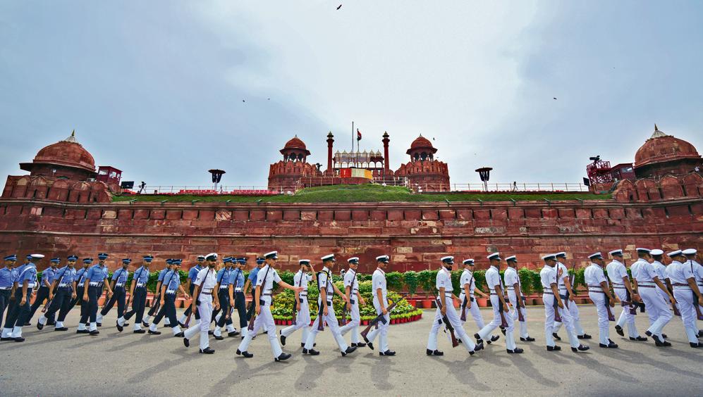 Indian Navy and Air Force personnel march during the full dress rehearsal for 79th Independence Day celebrations, at the Red Fort complex.