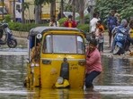 An auto-rickshaw driver pulls his vehicle through a waterlogged road, after eight gates of Himayat Sagar reservoir were opened, in Hyderabad, on Thursday (PTI) An auto-rickshaw driver pulls his vehicle through a waterlogged road, after eight gates of Himayat Sagar reservoir were opened, in Hyderabad, on Thursday (PTI)