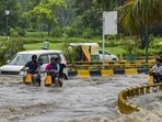 Commuters wade through a waterlogged road after rainfall near AIIMS in New Delhi on Thursday. (PTI) Commuters wade through a waterlogged road after rainfall near AIIMS in New Delhi on Thursday. (PTI)