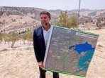 Israeli finance Minister Bezalel Smotrich holds a map of an area near the settlement of Maale Adumim, a land corridor known as E1, outside Jerusalem in the occupied West Bank.