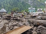 People move through the debris after a massive cloudburst at Chishoti village, in Jammu and Kashmir's Kishtwar district, Thursday, Aug. 14 (PTI)