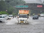 Vehicles wade through a waterlogged stretch during heavy rain on the Maharana Pratap Chowk near MDI Institute, in Gurugram on Thursday. (Parveen Kumar/HT Photo)