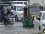Vehicles wade through logged rain water during a heavy rainfall at Pandav Nagar in New Delhi on Thursday. (RAJ K RAJ /HT PHOTO)
