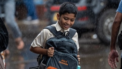 A school student clinches on to his bag as he wades through Mumbai's Dadar amid heavy rains. (Satish Bate/Hindustan Times)